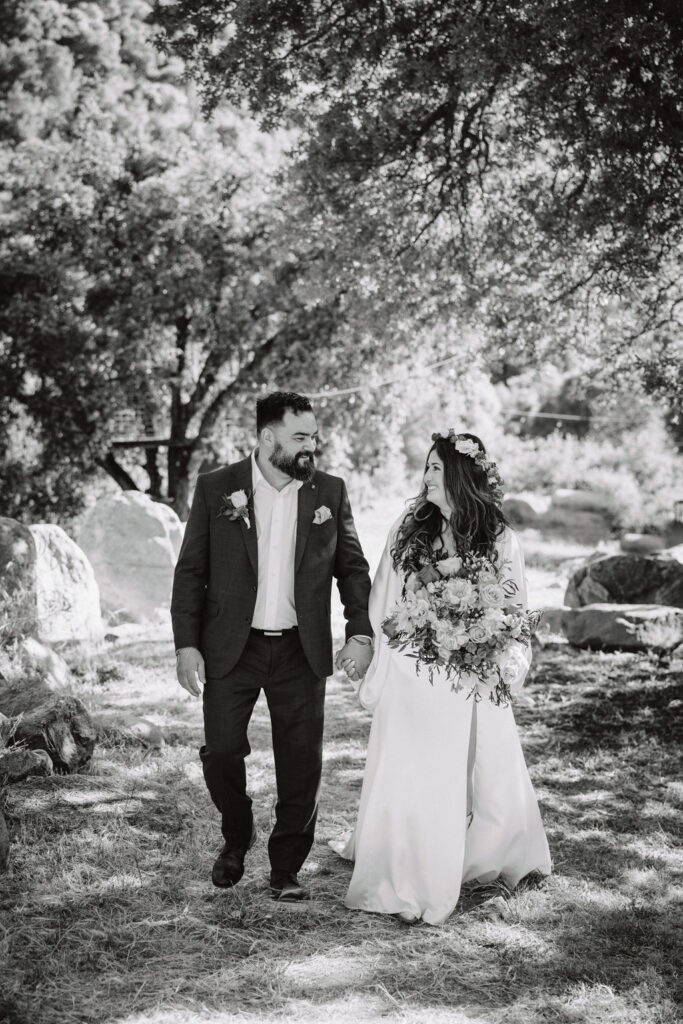 bride and groom posing for their outdoor wedding photos
