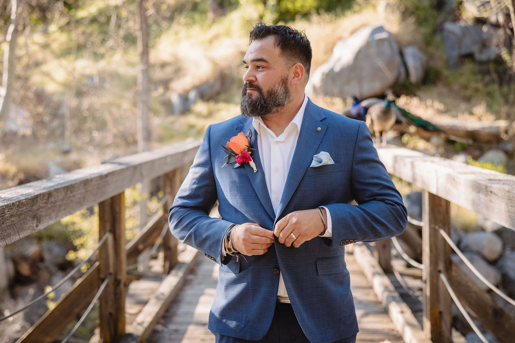 couple posing for their wedding portraits | groom getting ready photos during a redwood ranch wedding
