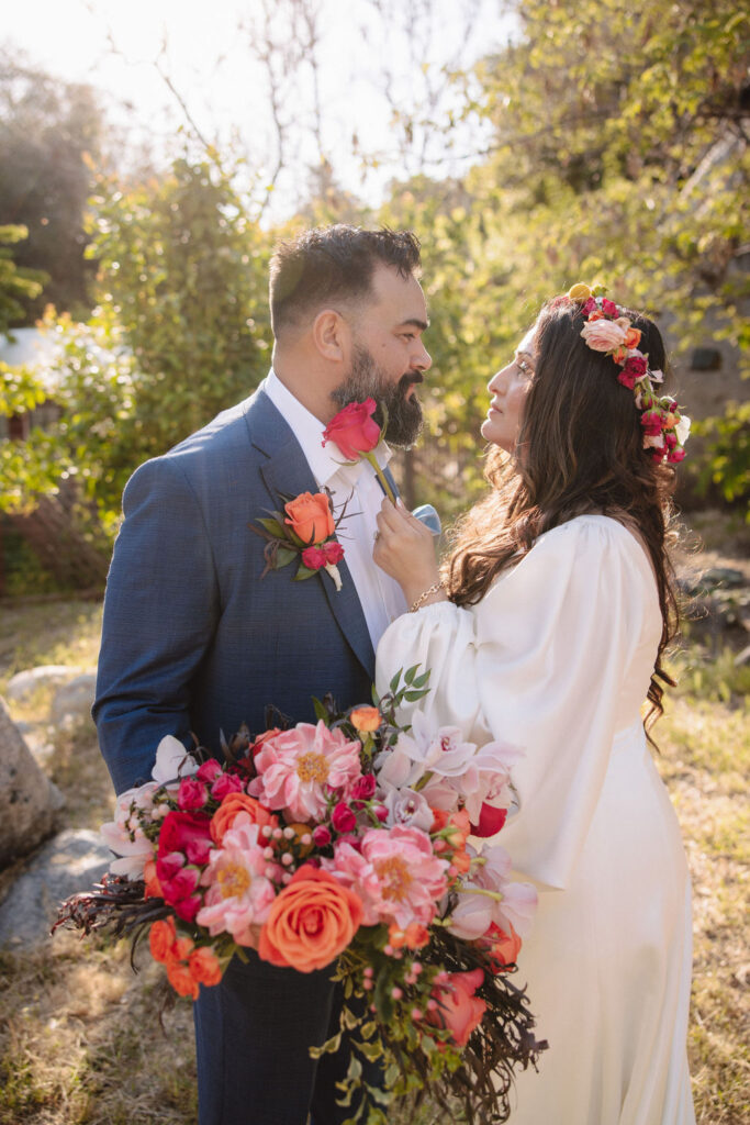 bride and groom posing for their outdoor wedding photos
