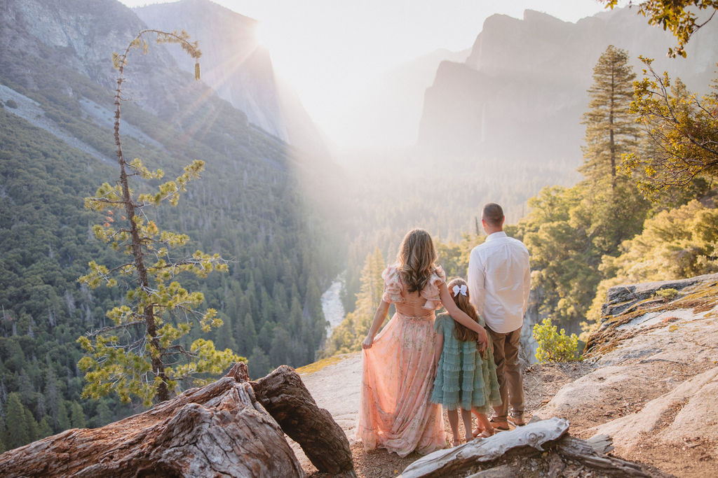 Family at Yosemite National park for their documentary style family photos looking out into the sunrise 