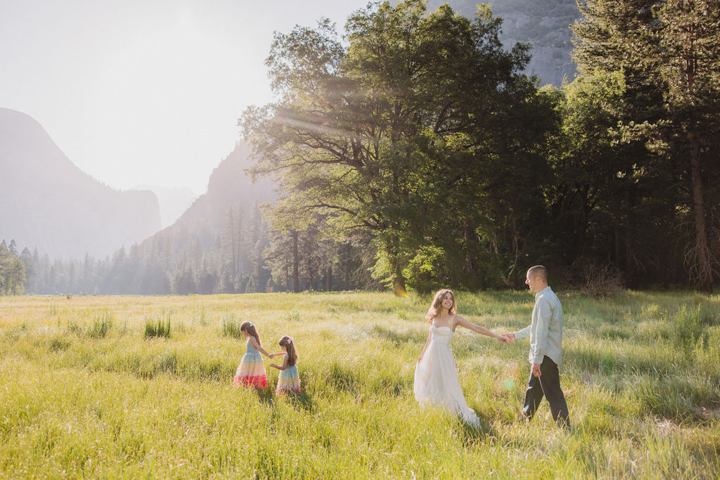 Family at Yosemite National park for their documentary style family photos walking into meadow