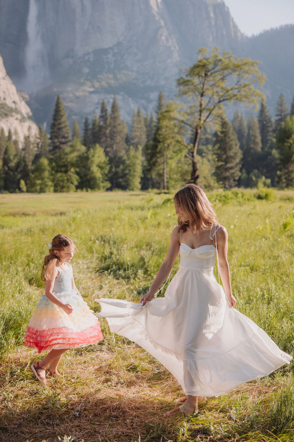 Family at Yosemite National park for their documentary style family photos walking into meadow and children running around