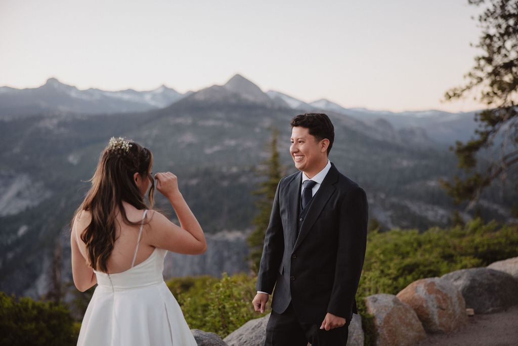 bride and groom sharing a first look at Yosemite national park during sunrise