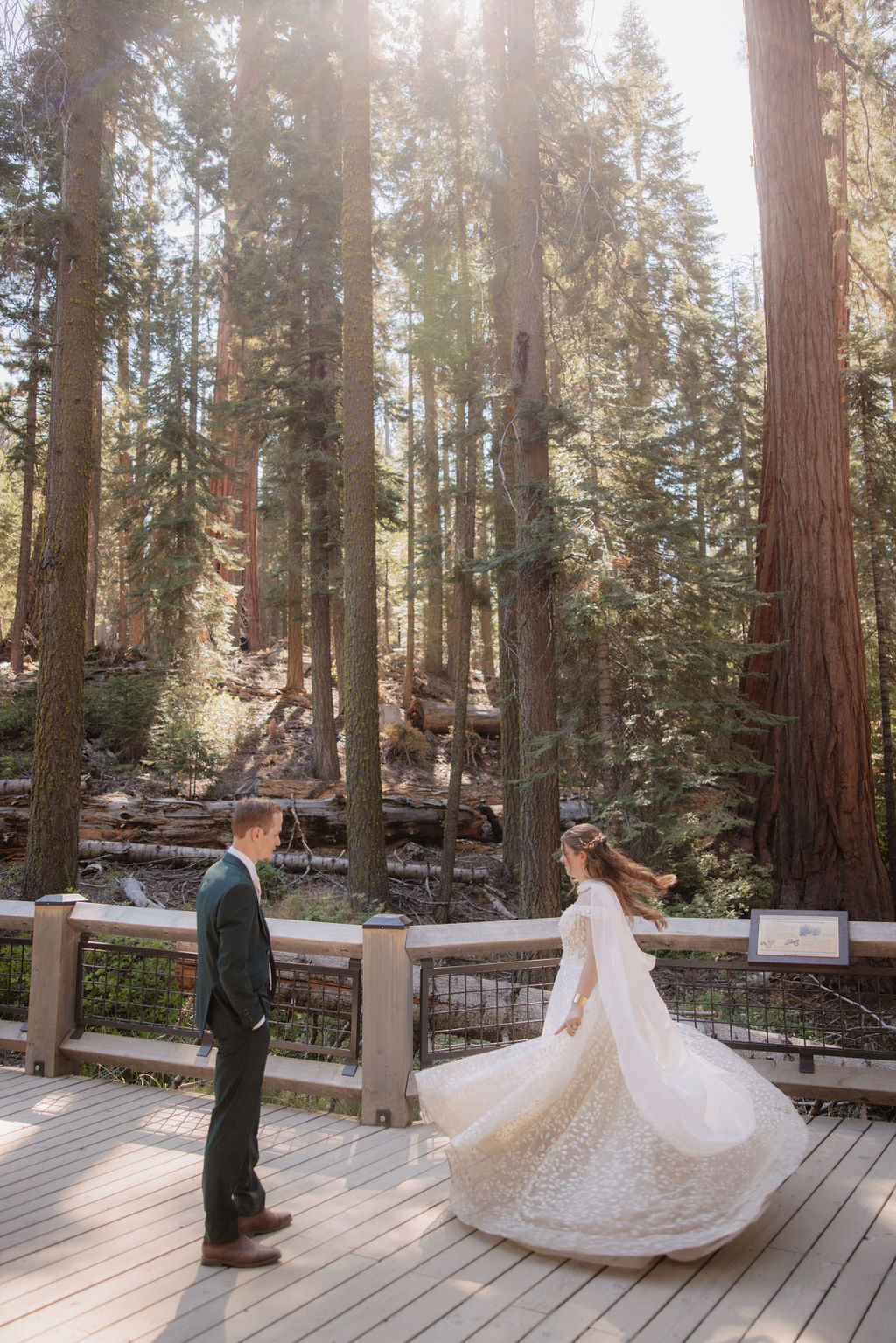 couple walking through mariposa grove at yosemite national park 