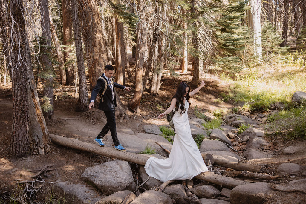 couple hiking through the woods during their yosemite elopement| best views at Yosemite National Park