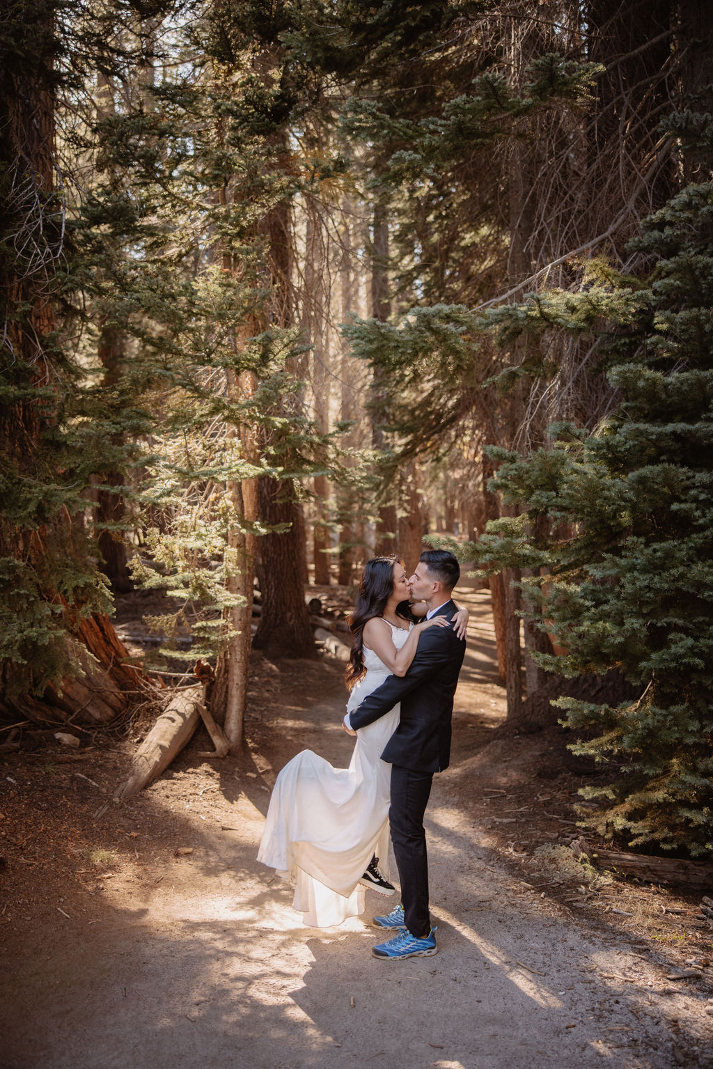 couple hiking through the woods during their yosemite elopement| best views at Yosemite National Park