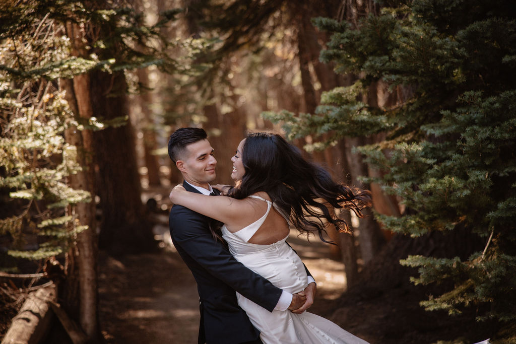 couple hiking through the woods during their yosemite elopement| best views at Yosemite National Park