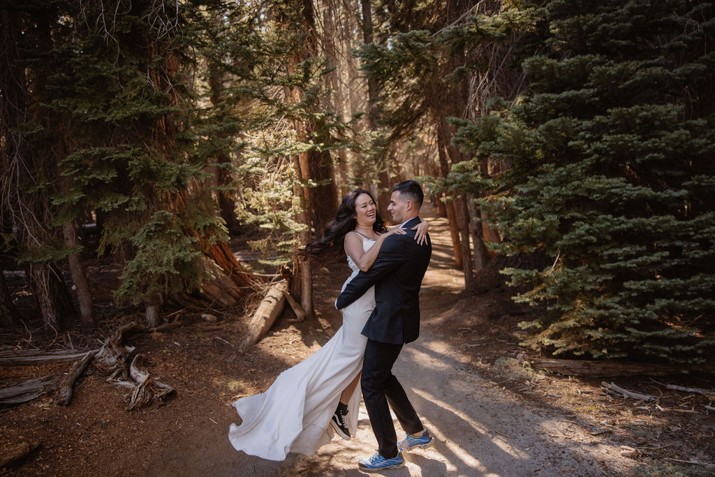 couple hiking through the woods during their yosemite elopement| best views at Yosemite National Park