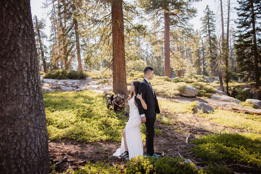 couple hiking through the woods during their yosemite elopement| best views at Yosemite National Park