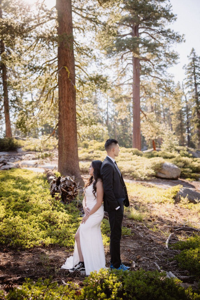 couple hiking through the woods during their yosemite elopement| best views at Yosemite National Park