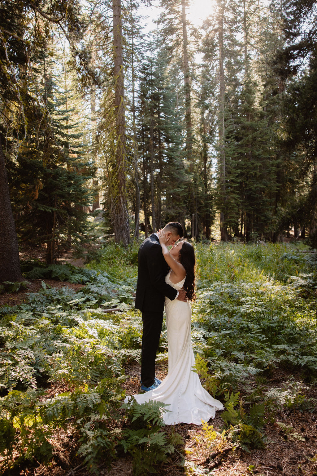 couple hiking through the woods during their yosemite elopement| best views at Yosemite National Park