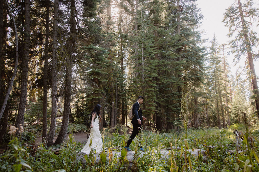 couple hiking through the woods during their yosemite elopement| best views at Yosemite National Park