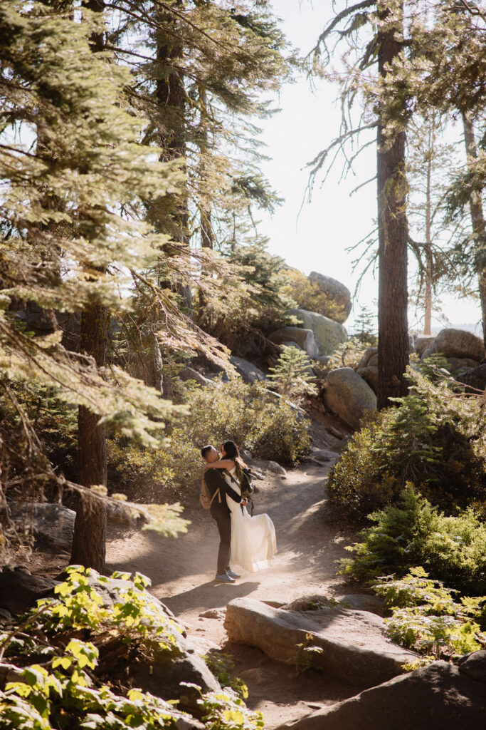  couple hiking through the woods during their yosemite elopement| best views at Yosemite National Park