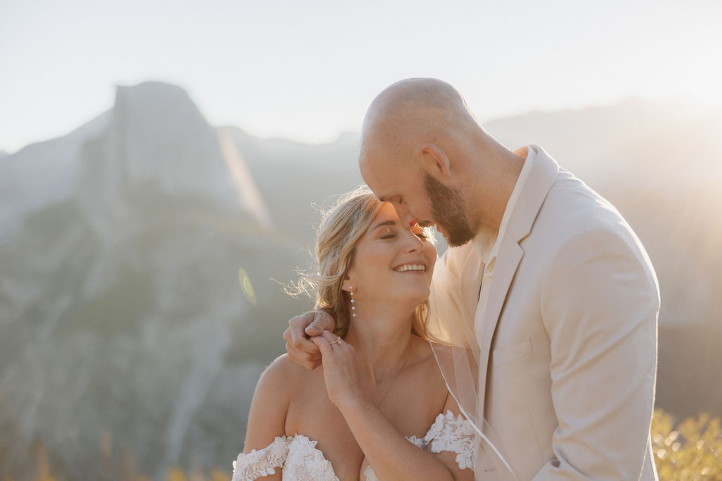 bride and groom take wedding portraits at glacier point for their yosemite wedding