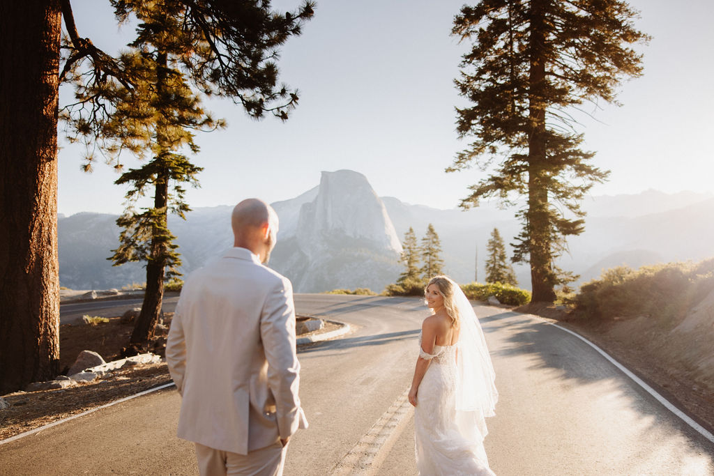 bride and groom take wedding portraits at glacier point for their yosemite wedding