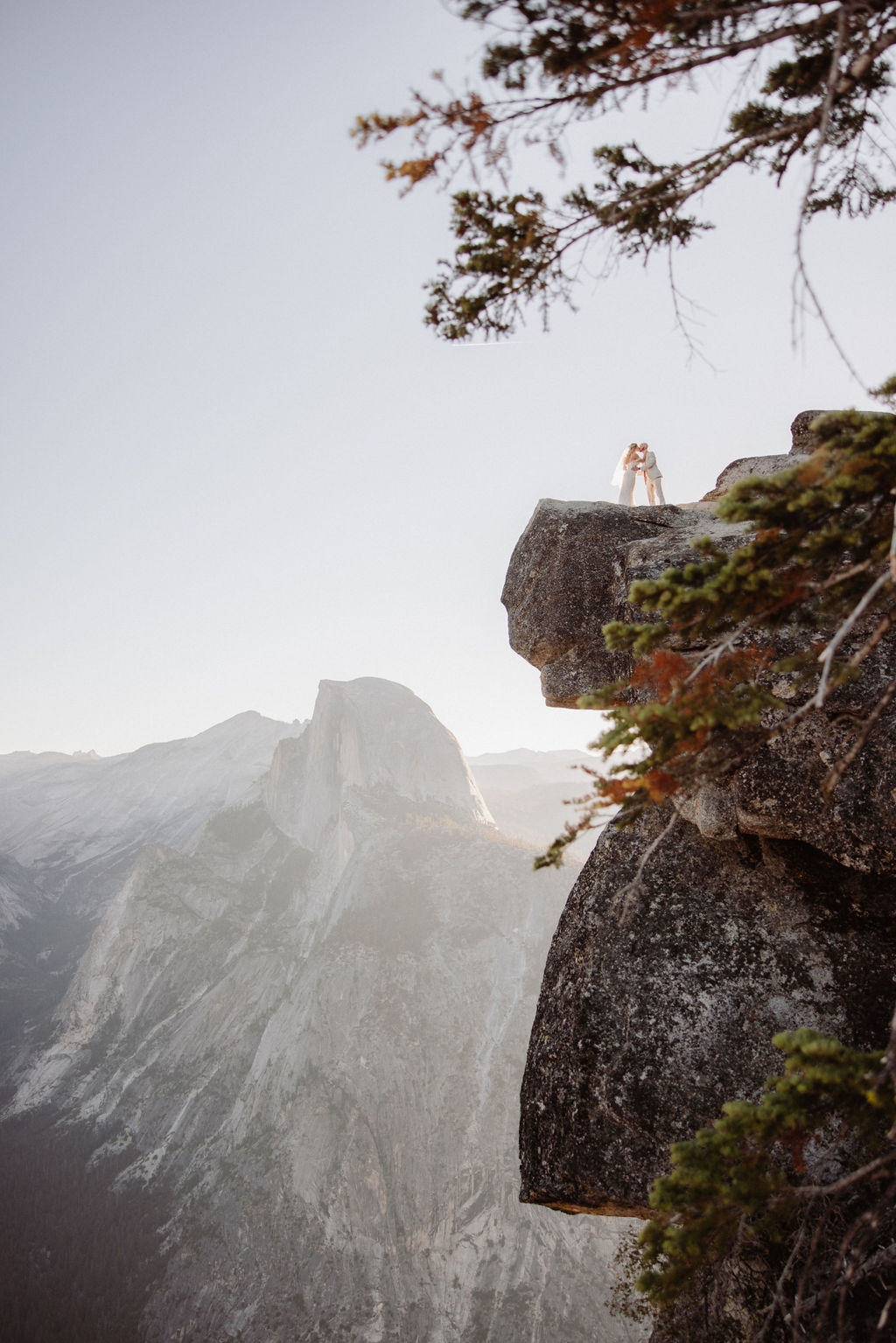 bride and groom take wedding portraits at glacier point for their yosemite wedding