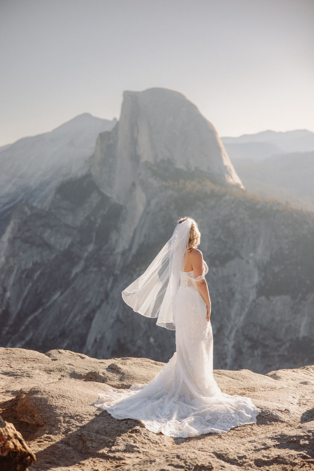 bride and groom take wedding portraits at glacier point for their yosemite wedding