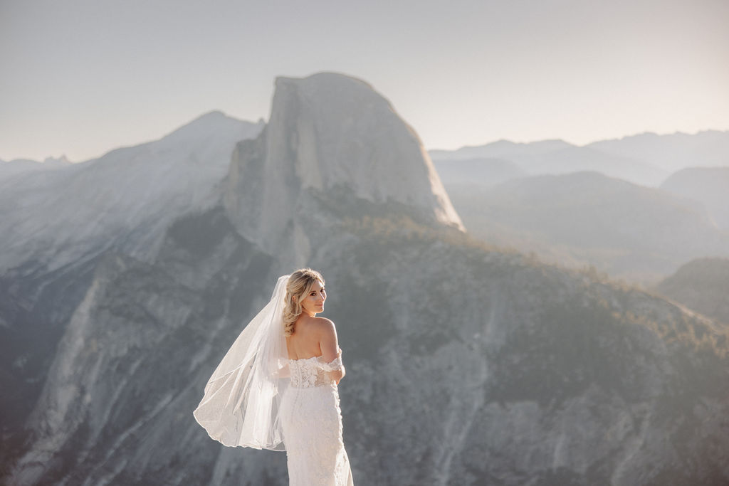 bride and groom take wedding portraits at glacier point for their yosemite wedding