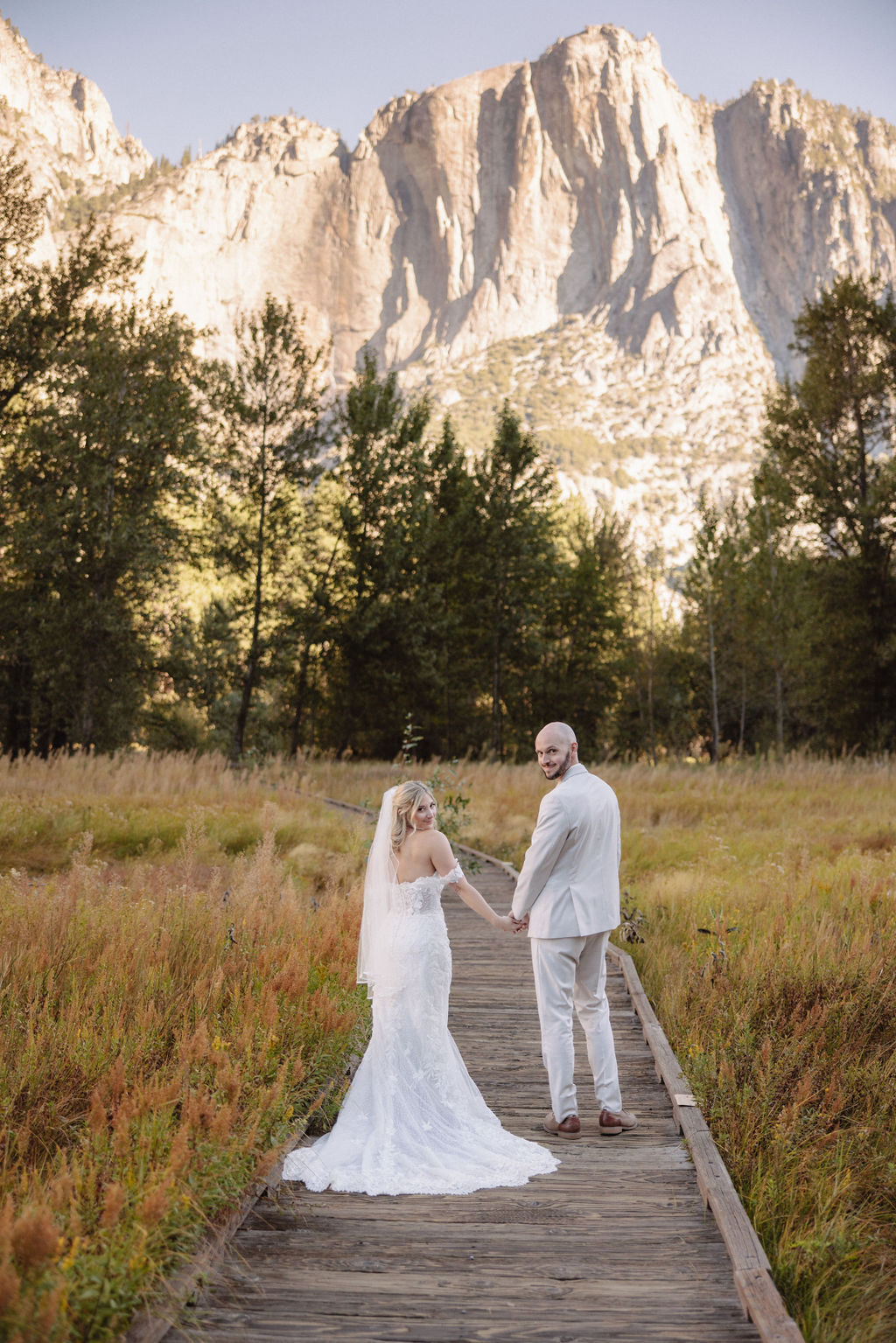 bride and groom take wedding portraits at Yosemite valley for their yosemite wedding