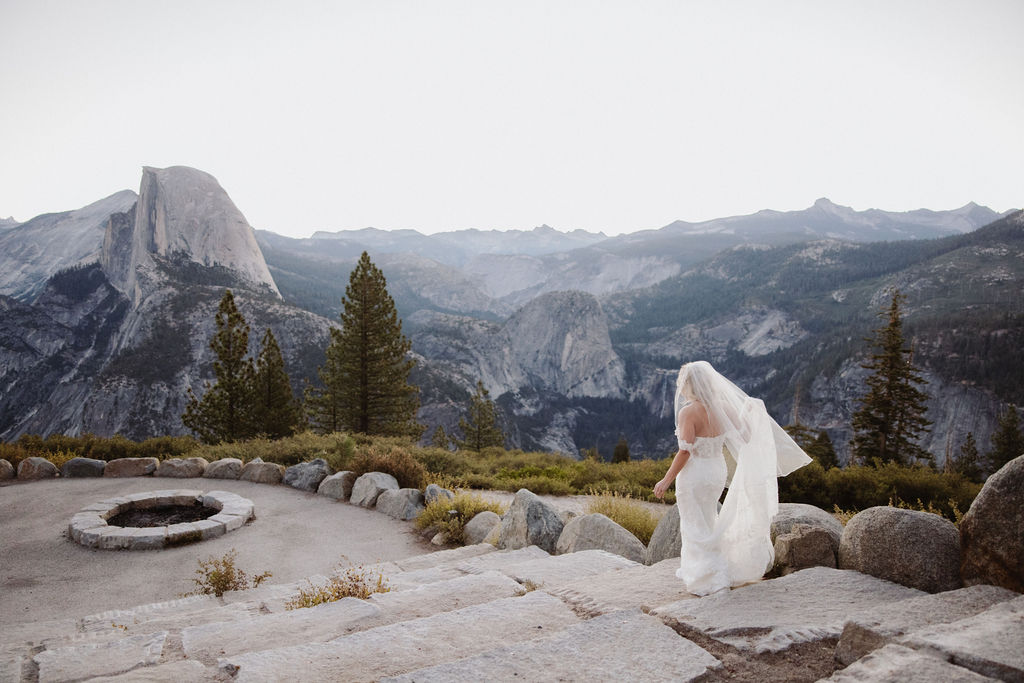 bride and groom take wedding portraits at glacier point for their yosemite wedding