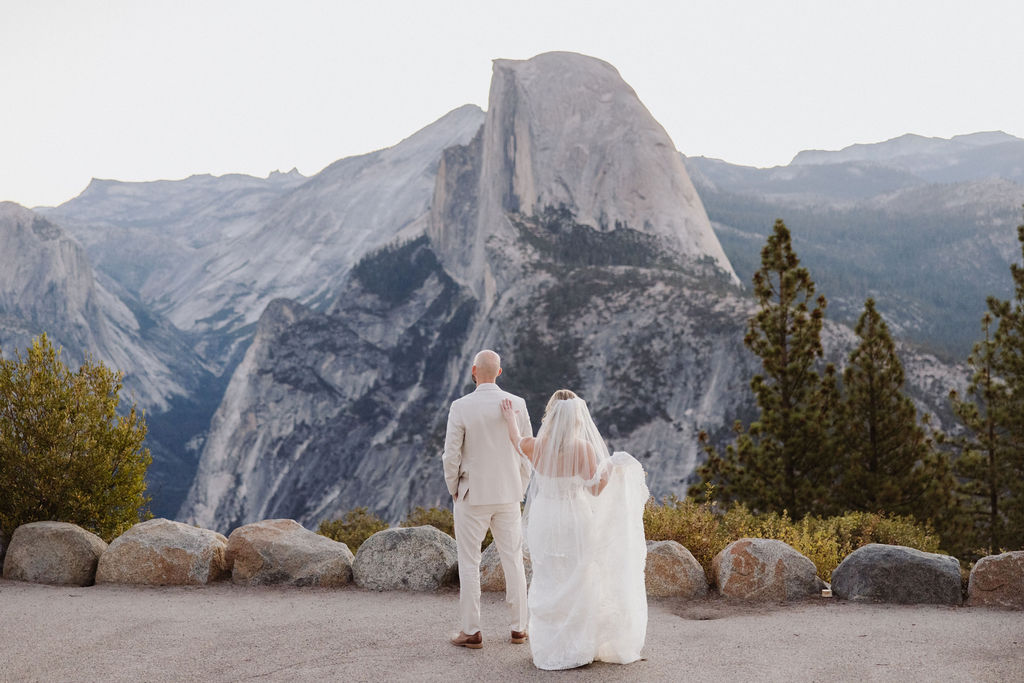 bride and groom take wedding portraits at glacier point for their yosemite wedding