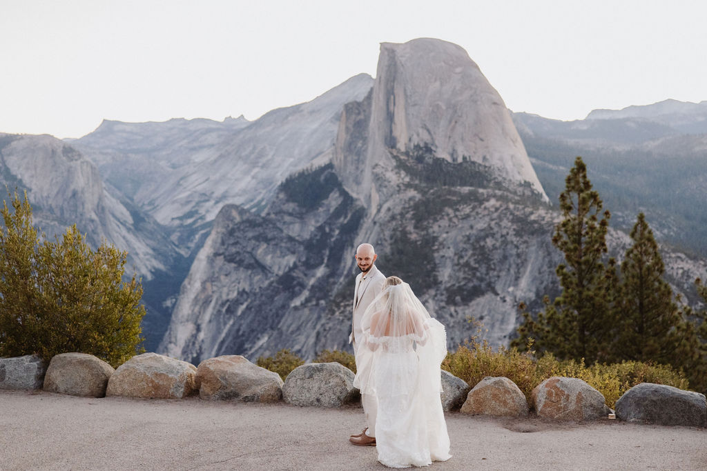 bride and groom take wedding portraits at glacier point for their yosemite wedding