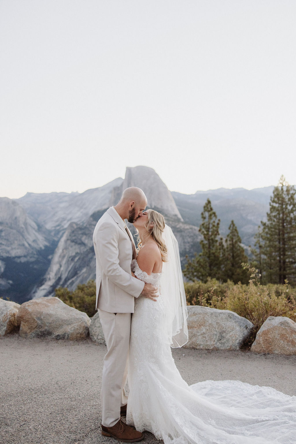 bride and groom take wedding portraits at glacier point for their yosemite wedding