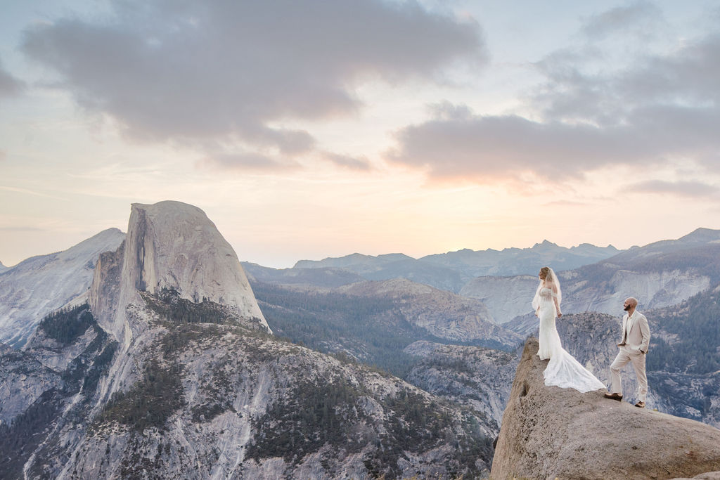 bride and groom take wedding portraits at glacier point for their yosemite wedding