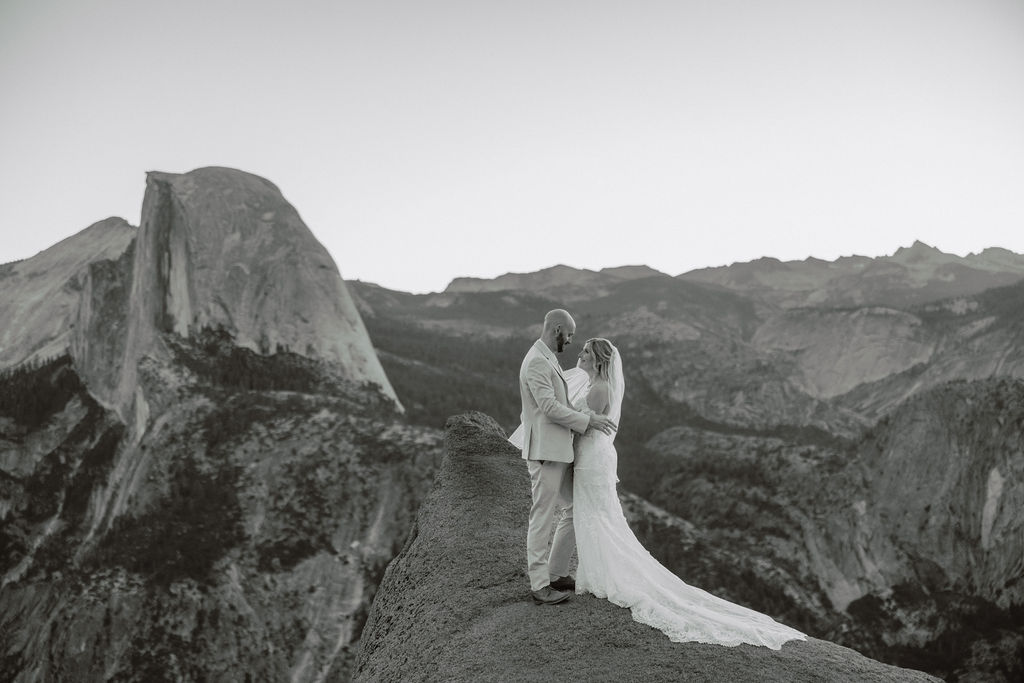 bride and groom take wedding portraits at glacier point for their yosemite wedding