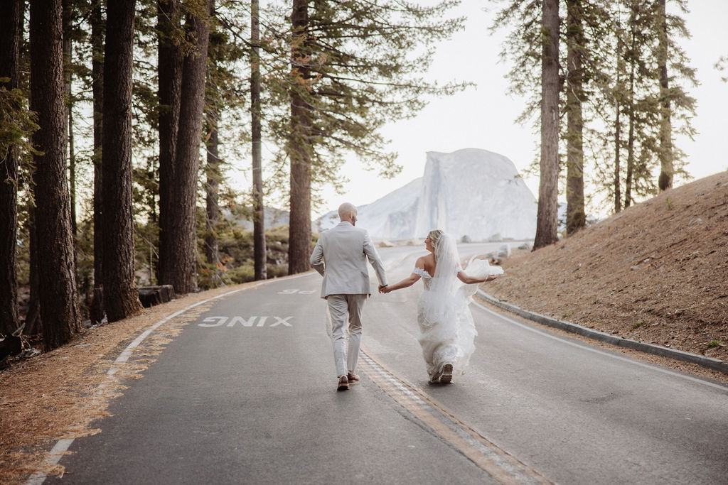 bride and groom take wedding portraits at glacier point for their yosemite wedding