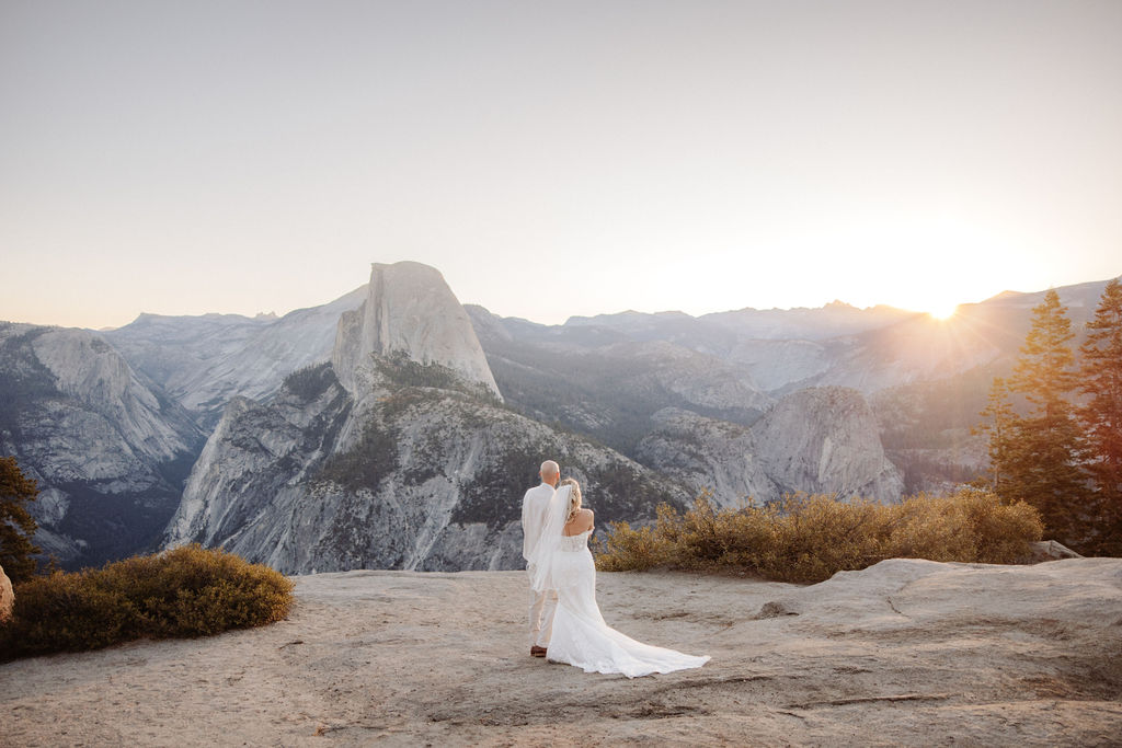 bride and groom take wedding portraits at glacier point for their yosemite wedding