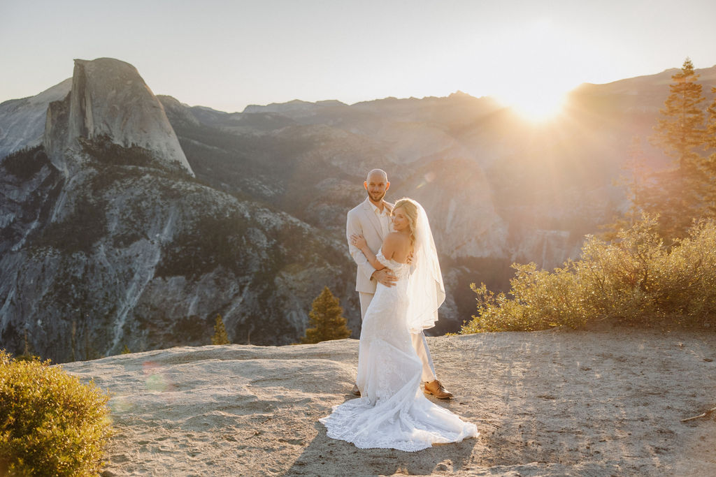 bride and groom take wedding portraits at glacier point for their yosemite wedding