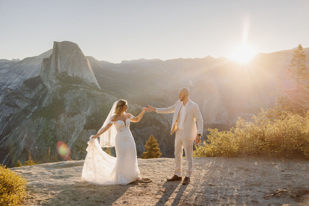 bride and groom take wedding portraits at glacier point for their yosemite wedding