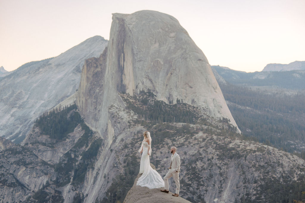 bride and groom take wedding portraits at glacier point for their yosemite wedding