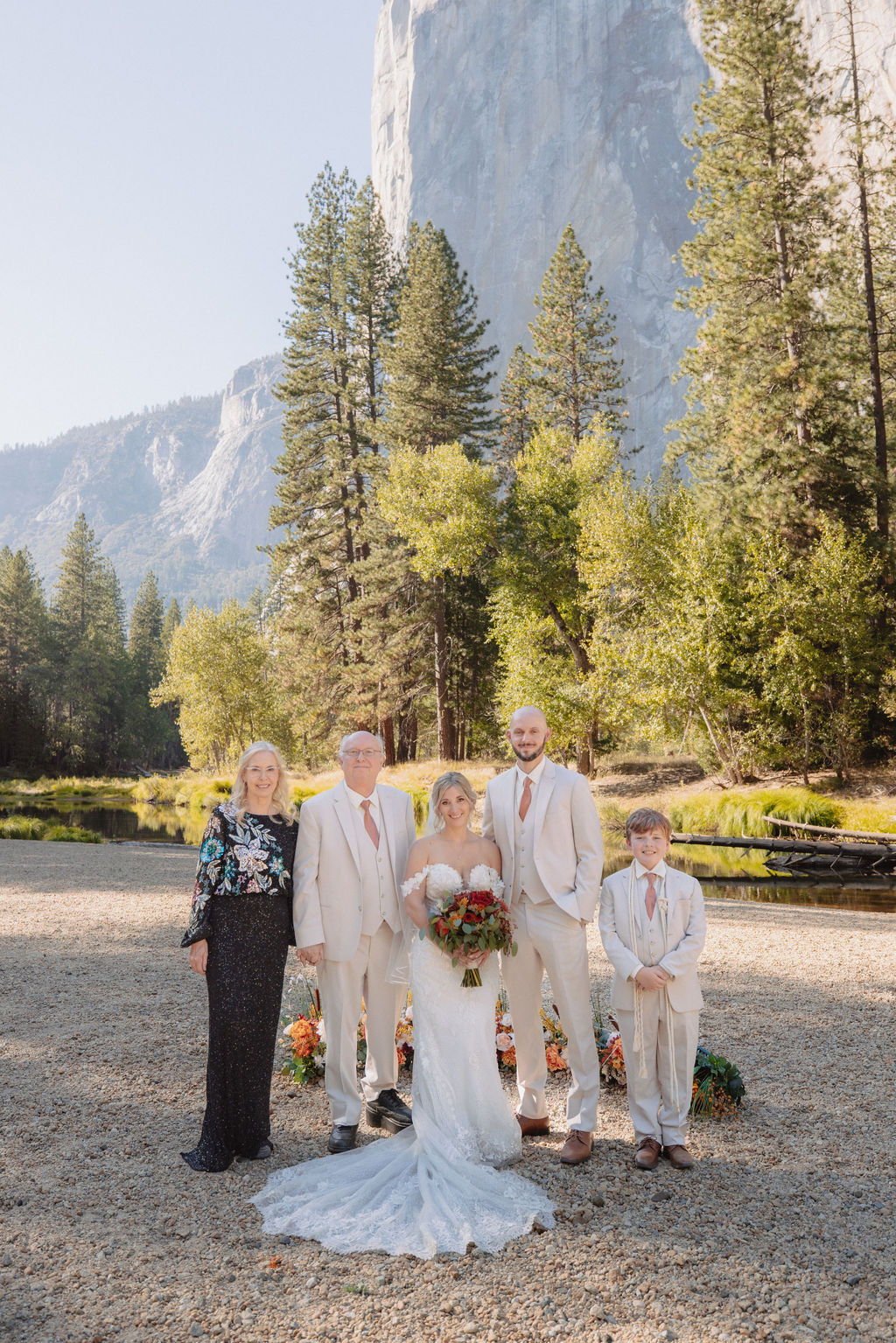 bride and groom take family portraits with family at a yosemite wedding