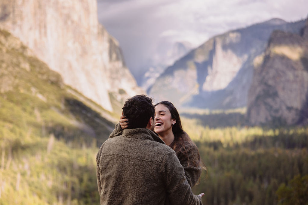 a couple takes photos at tunnel view after a proposal