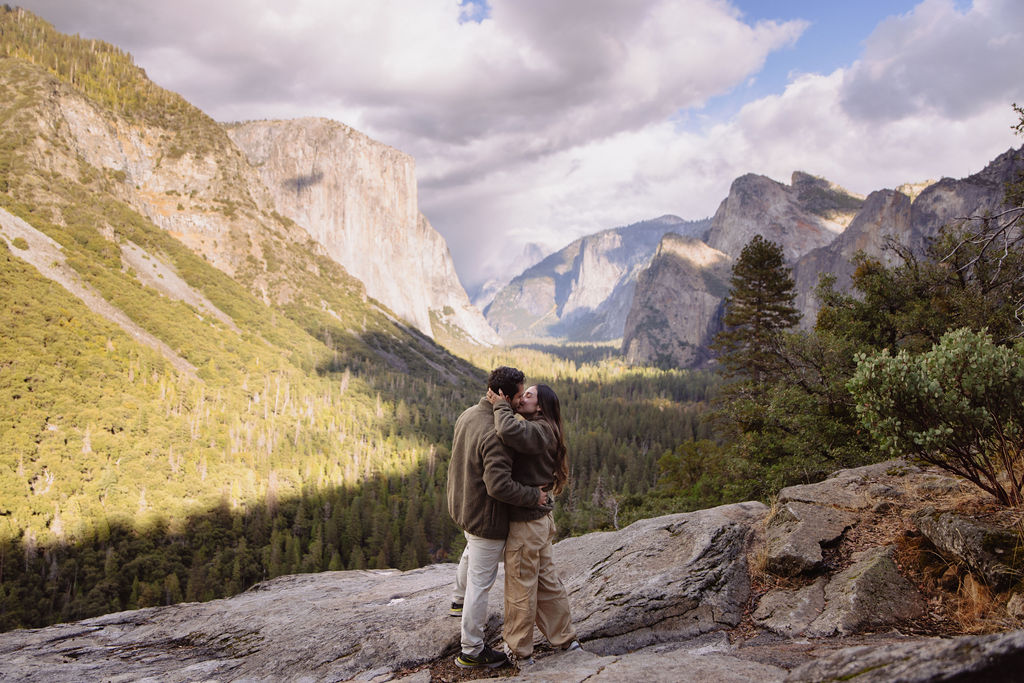 a couple takes photos at tunnel view after a proposal