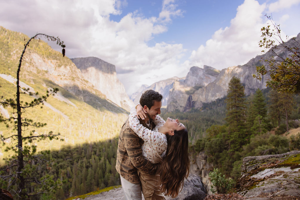 a couple takes photos at tunnel view after a proposal at yosemite national park