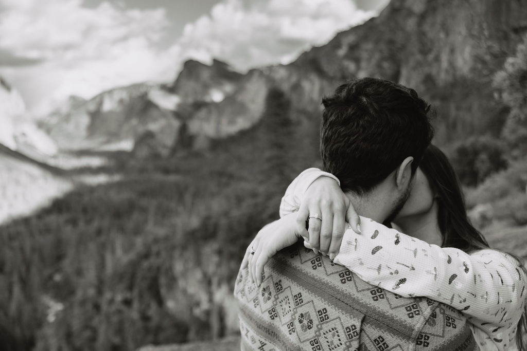 a couple takes photos at tunnel view after a proposal at yosemite national park