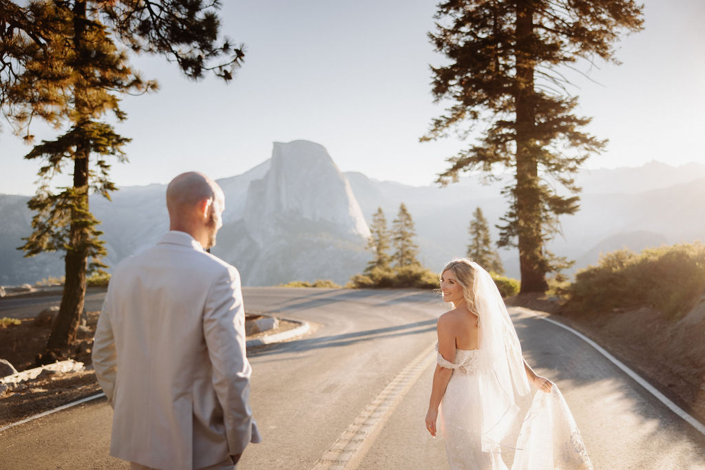 couple running through the road at in yosemite for eloping in a national park