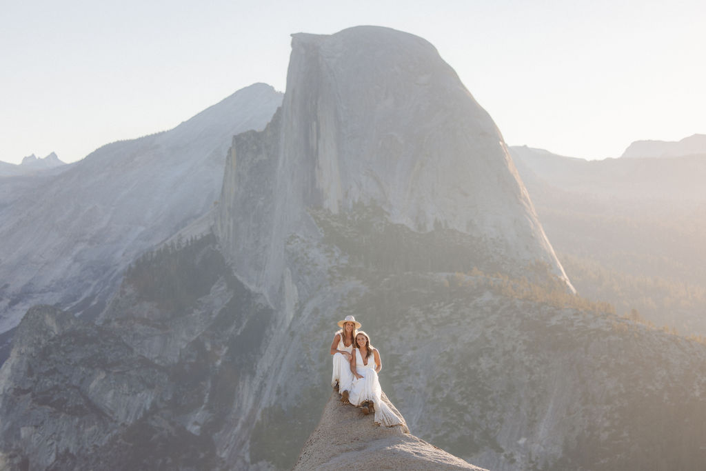 A couple sitting on a rock at for their elopement at Yosemite