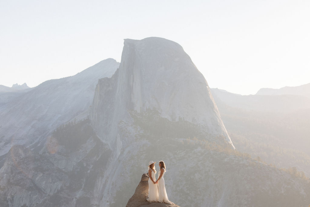 A couple sitting on a rock at for their elopement at Yosemite