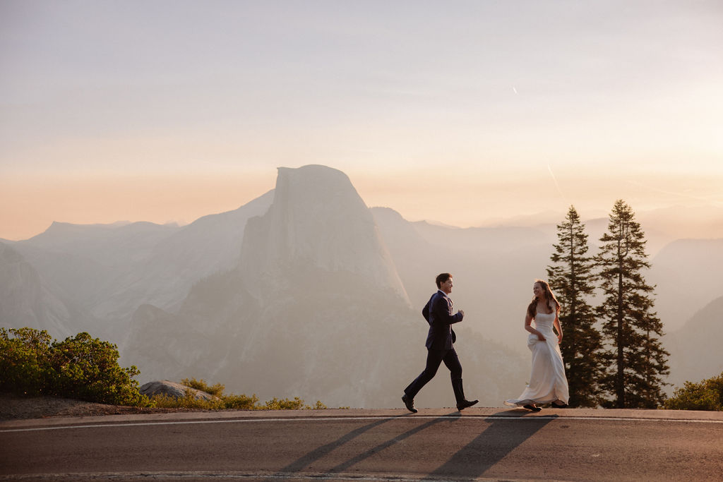A man and woman holding hands on a road.