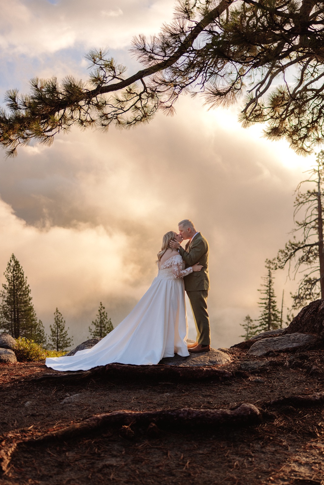 Bride and groom kiss during emotional first look in Yosemite National Park