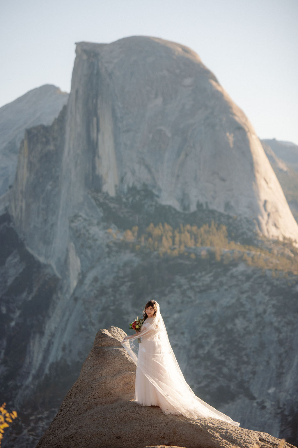Bride poses at her early morning Yosemite elopement
