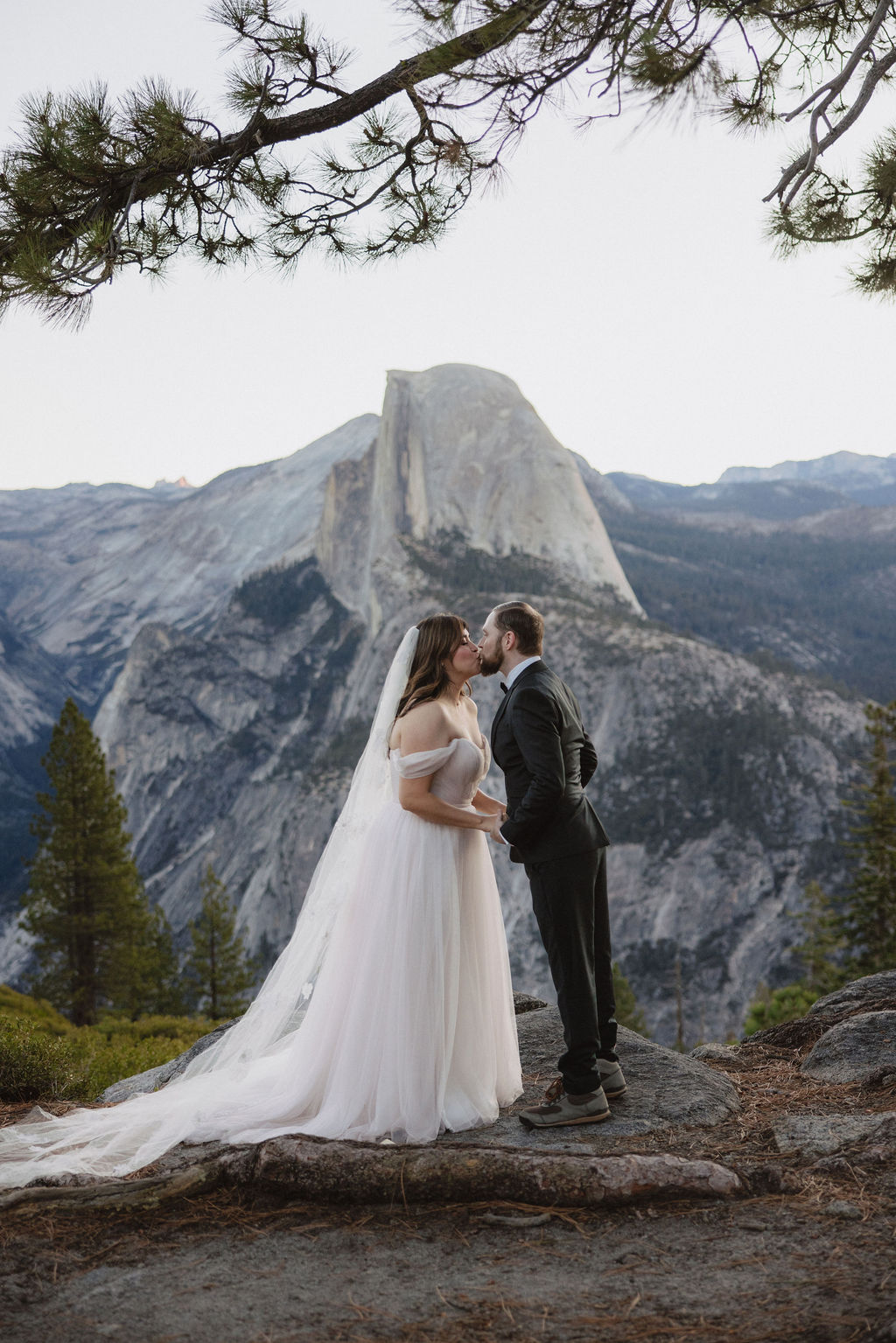 Bride and groom kiss at their early morning Yosemite elopement ceremony