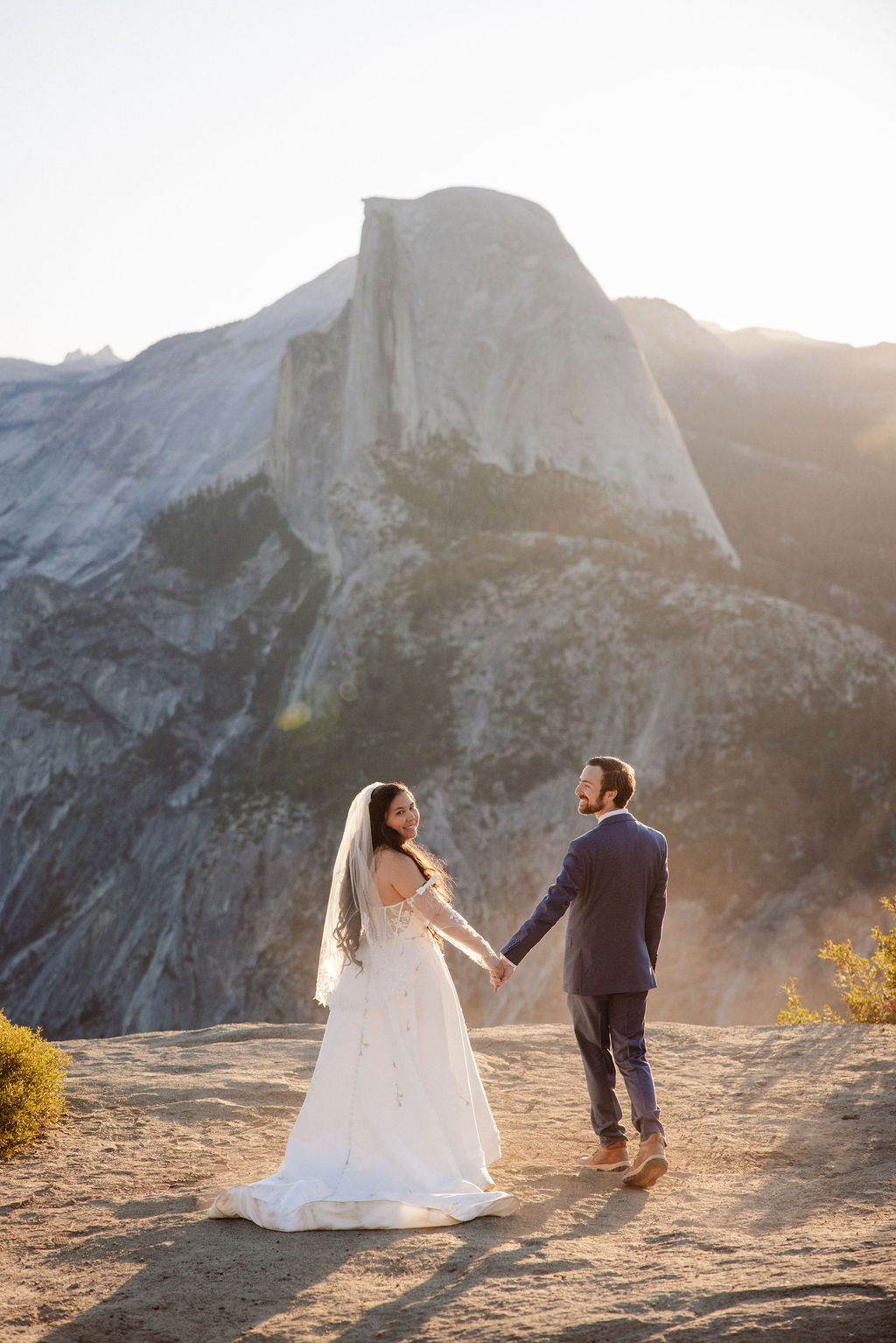 Bride and groom holding hands in Yosemite National Park