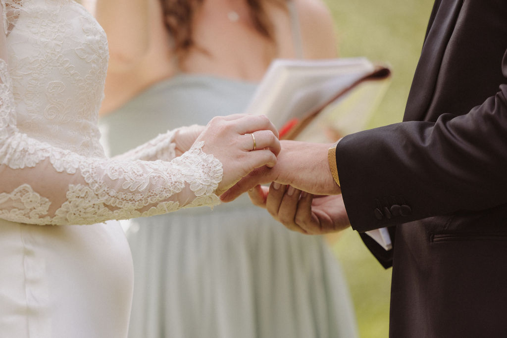 Bride and groom hold hands during Ahwahnee Yosemite wedding vows