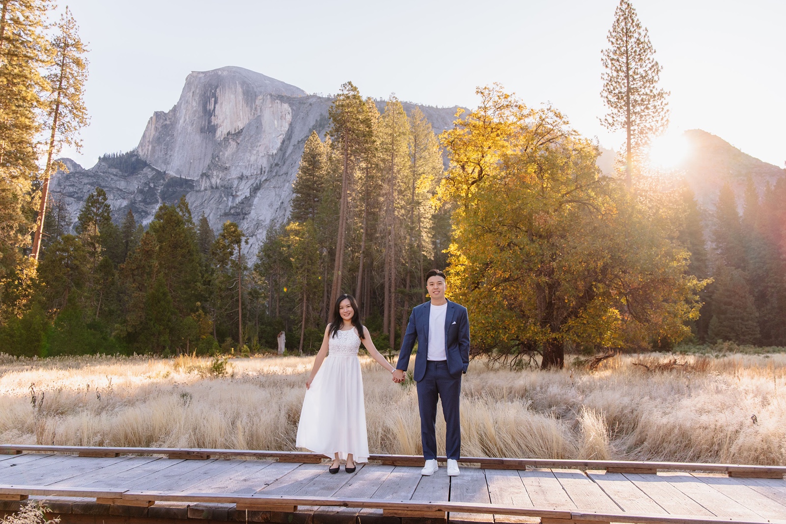 Bride and groom hold hands at Half Dome Meadow in Yosemite