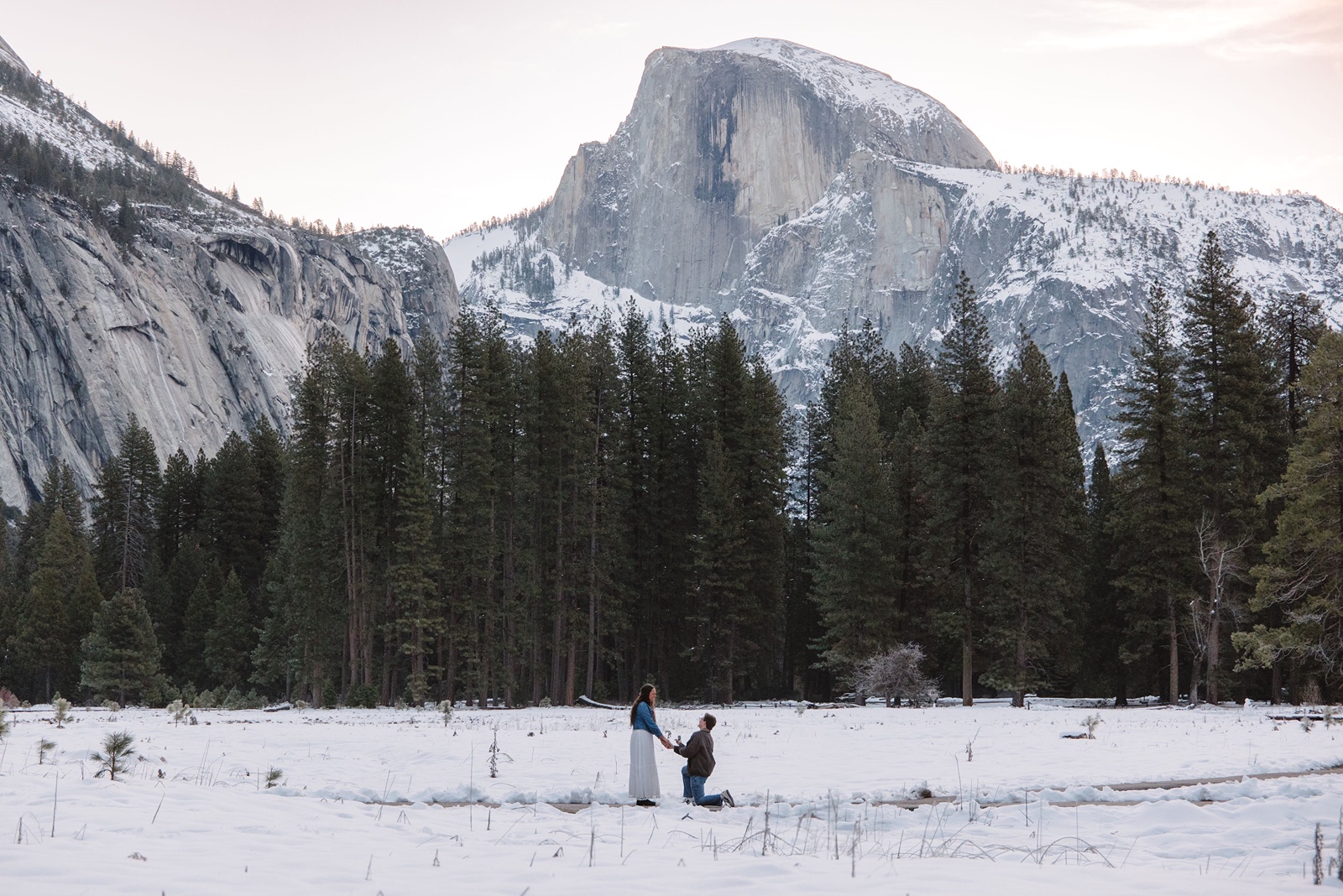 Man proposes to woman in Cooks Meadow in Yosemite